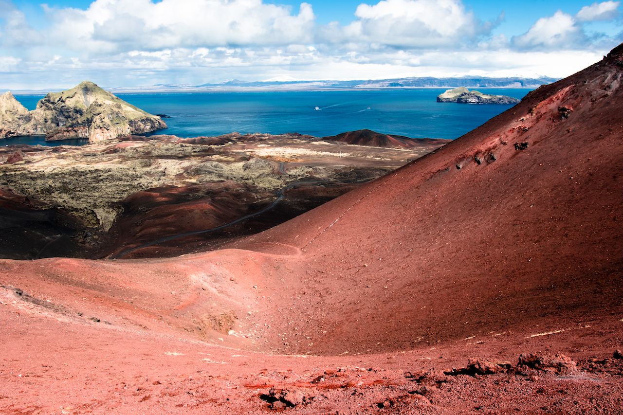 Beautiful colorful red lava stones and rocks on the top of volcano mountain in Westman islands Iceland