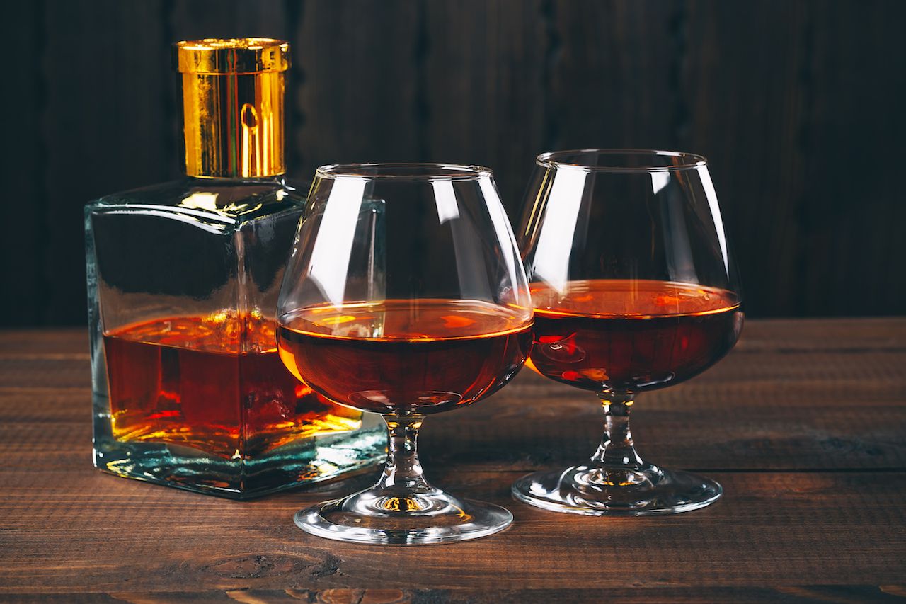 Glass of brandy or cognac on the wooden table